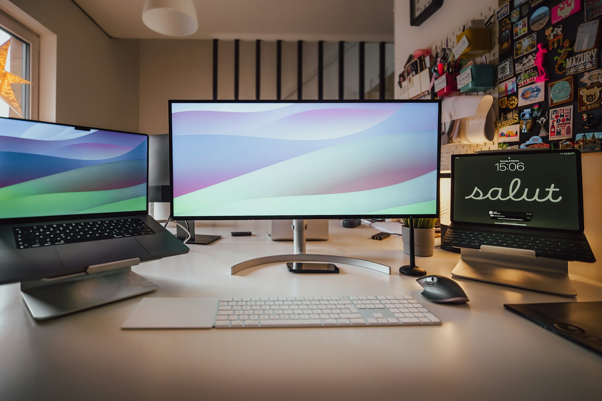 a desk with three computer monitors and a keyboard